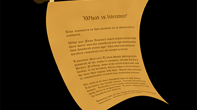 A twisted parchment attached to a rod has old-fashioned letters spelling out the title What is literature?  5 paragraphs follow but they are hard to read.